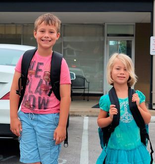 Two children excited about school, but educational testing/an independent educational evaluation may help to meet their needs.