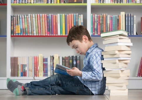 Although surrounded by books, this boy’s learning disability may make learning to read difficult without special education. 
